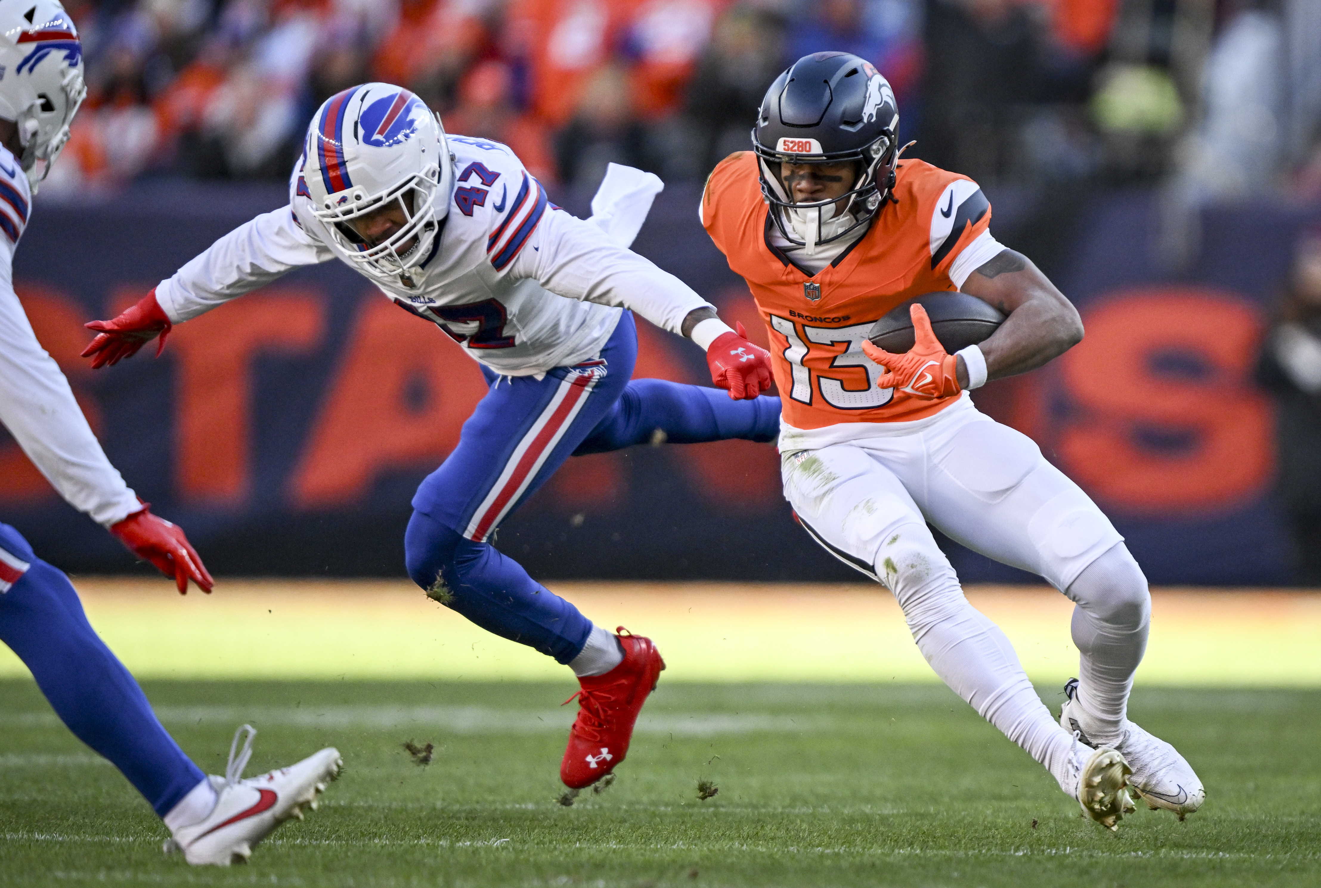 Pat Bryant (13) of the Denver Broncos sheds Christian Benford (47) of the Buffalo Bills after making a catch during the first quarter at Empower Field at Mile High in Denver, Colorado on Saturday, January 17, 2026. (Photo by AAron Ontiveroz/The Denver Post)