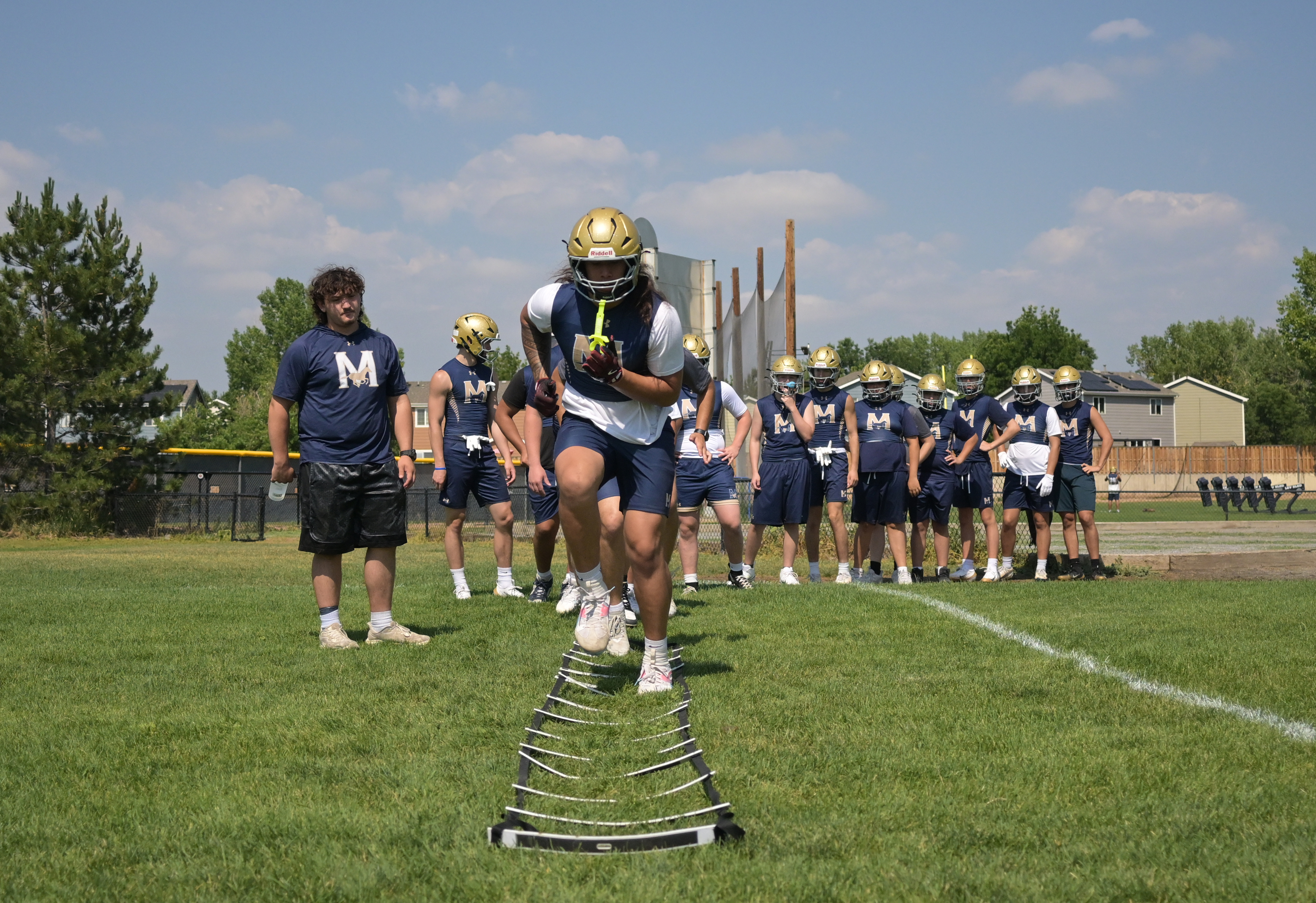 Troy Mailo, center, is expected to be one of the top player in the 2027 high school class as an edge rusher for Mullen High School. Mailo works on drills during summer workouts at Mullen High School on Tuesday, June 23, 2026, in Denver. (Photo by RJ Sangosti/The Denver Post)