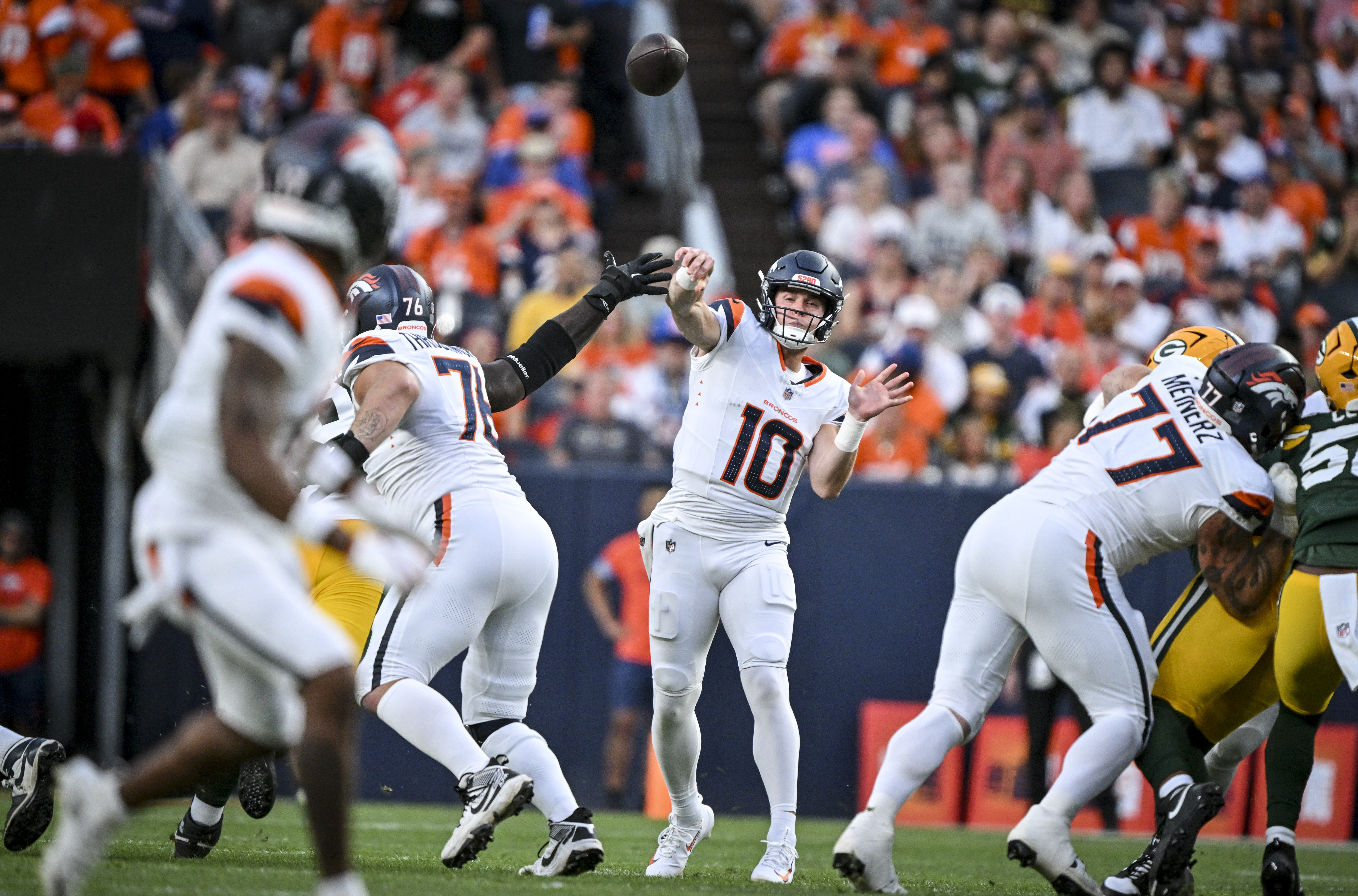 Bo Nix (10) of the Denver Broncos throws deep to Jaylen Waddle (17) during the first quarter against the Green Bay Packers at Empower Field at Mile High in Denver, Colorado on Friday, August 21, 2026. (Photo by AAron Ontiveroz/The Denver Post)