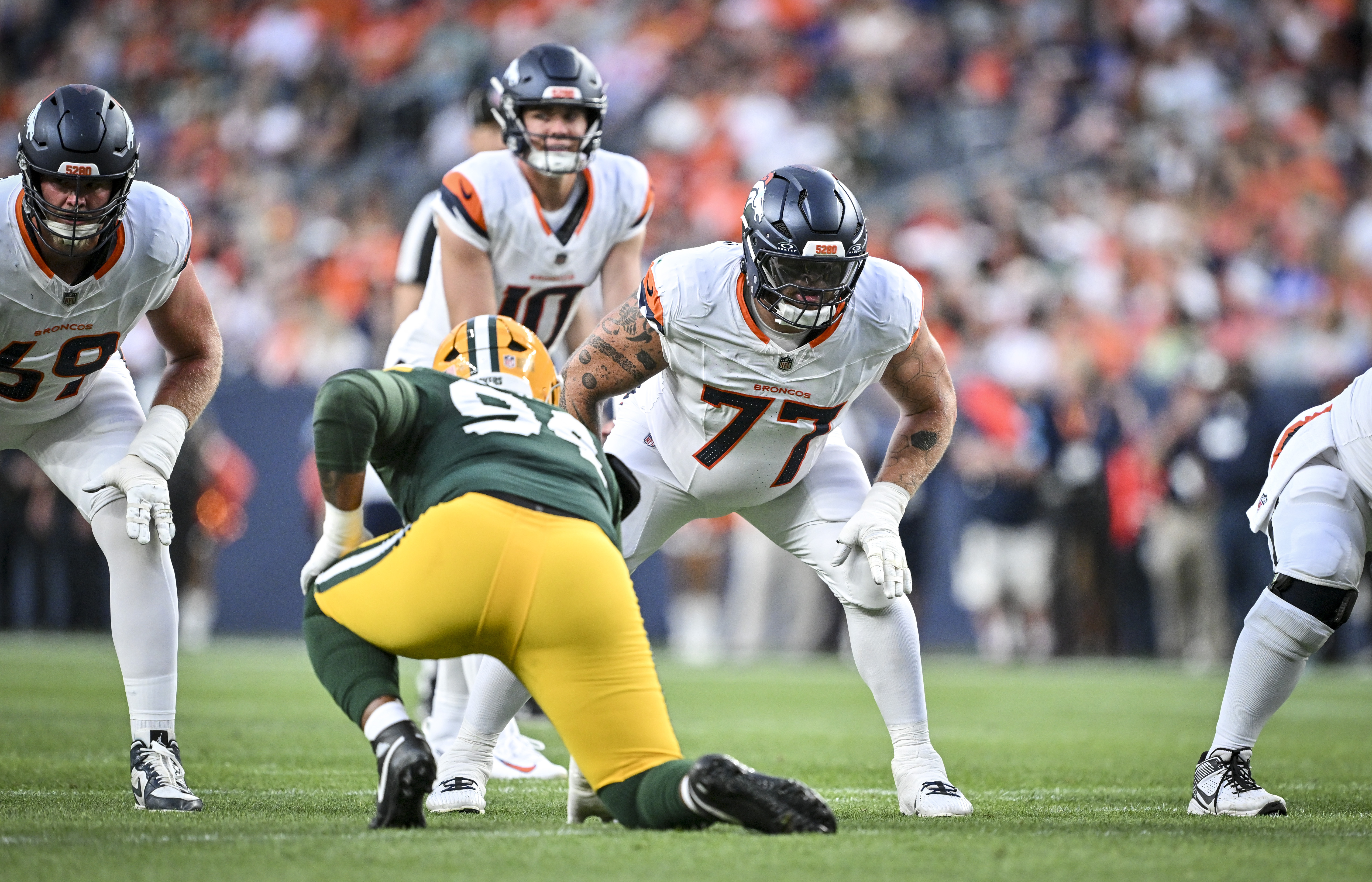 DENVER , CO - AUGUST 21: Quinn Meinerz (77) of the Denver Broncos prepares to protect Bo Nix (10) during the first quarter against the Green Bay Packers at Empower Field at Mile High in Denver, Colorado on Friday, August 21, 2026. (Photo by AAron Ontiveroz/The Denver Post)