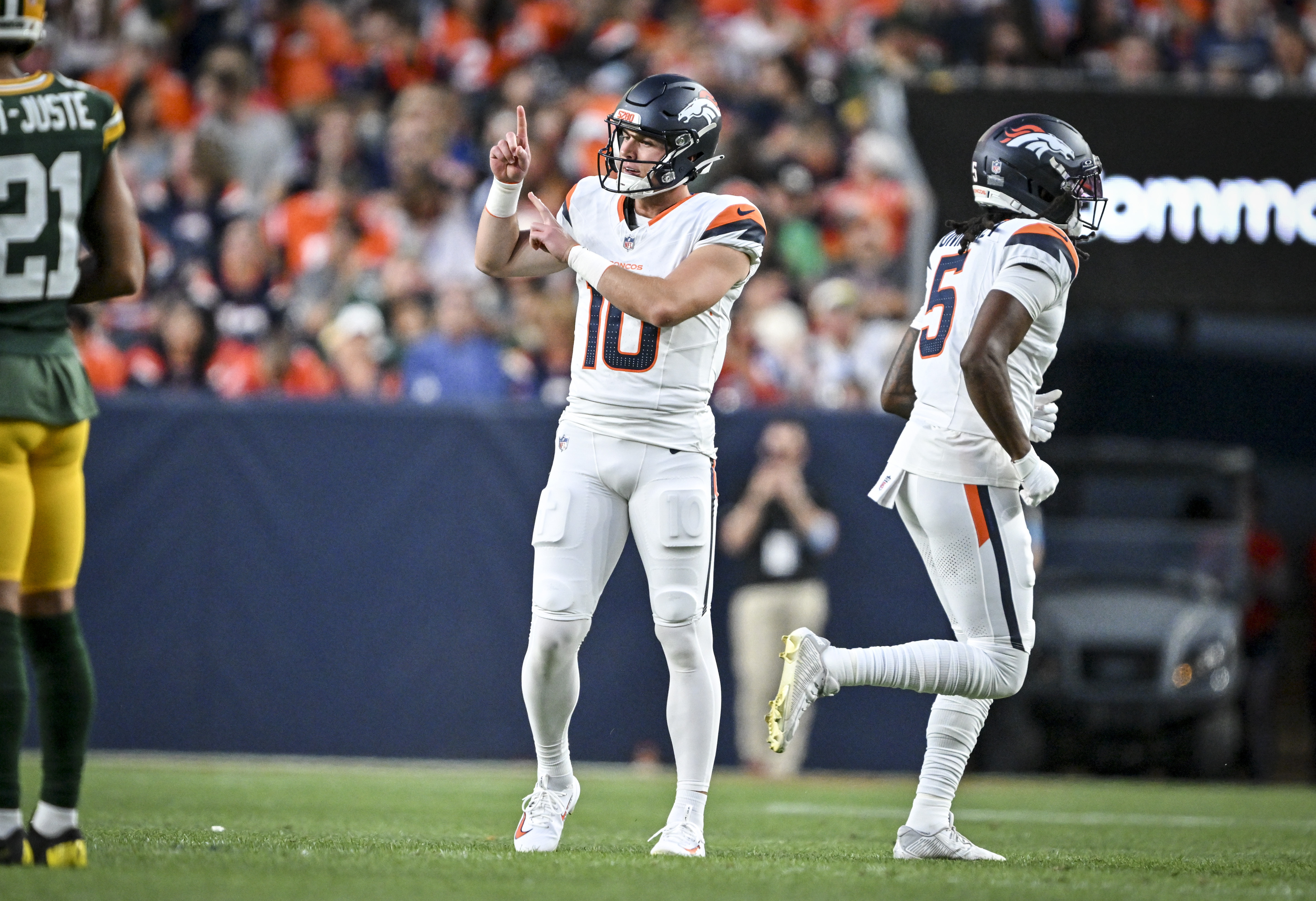 Bo Nix (10) of the Denver Broncos signals to teammates as Lil'jordan Humphrey (5) runs off the field during the first quarter against the Green Bay Packers at Empower Field at Mile High in Denver, Colorado on Friday, August 21, 2026. (Photo by AAron Ontiveroz/The Denver Post)