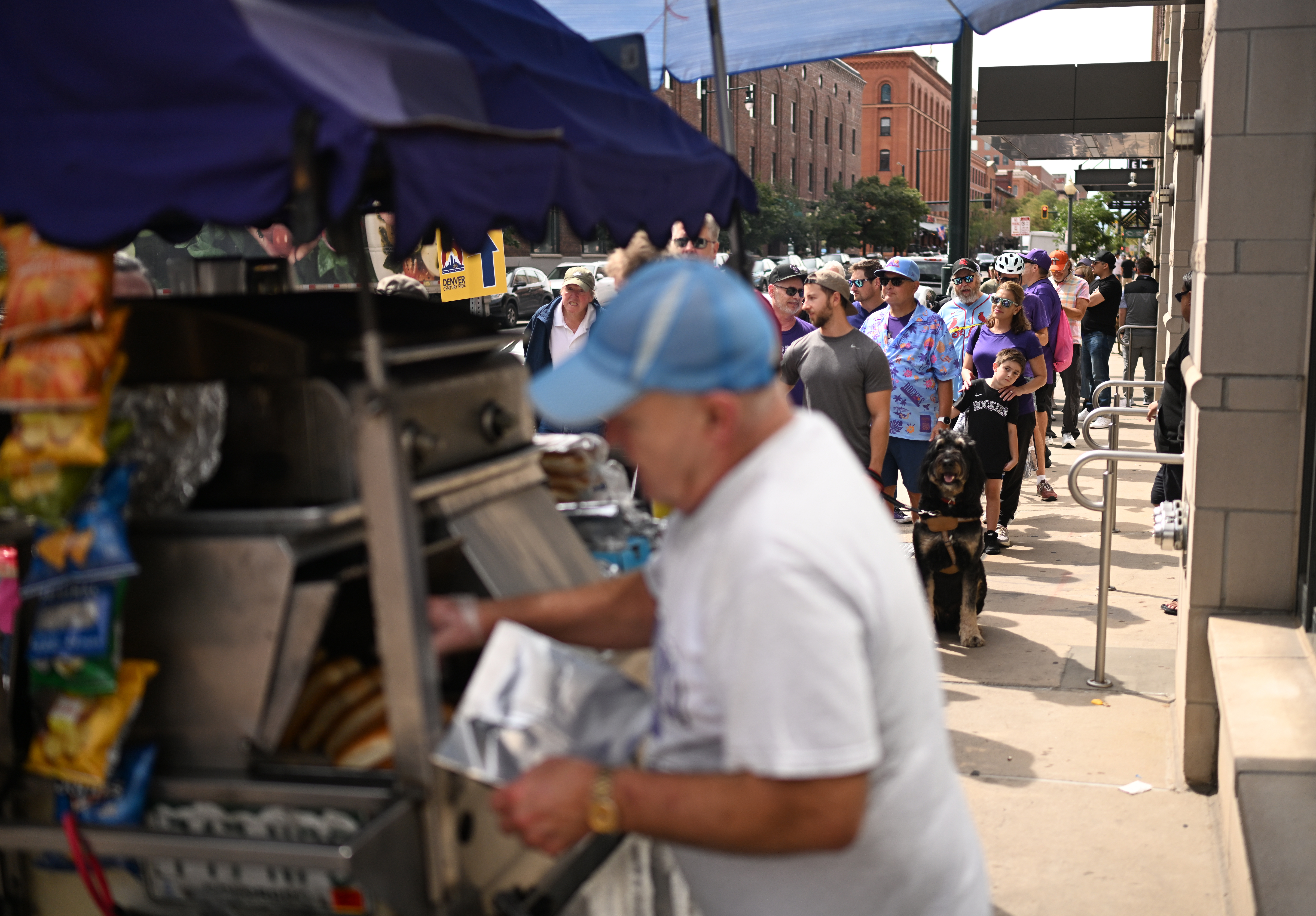 A long line forms at Joel Watkins' hot dog stand on his last day of business at 19th and Wynkoop streets on Thursday, Sept. 24, 2026, in Denver. (Photo by RJ Sangosti/The Denver Post)