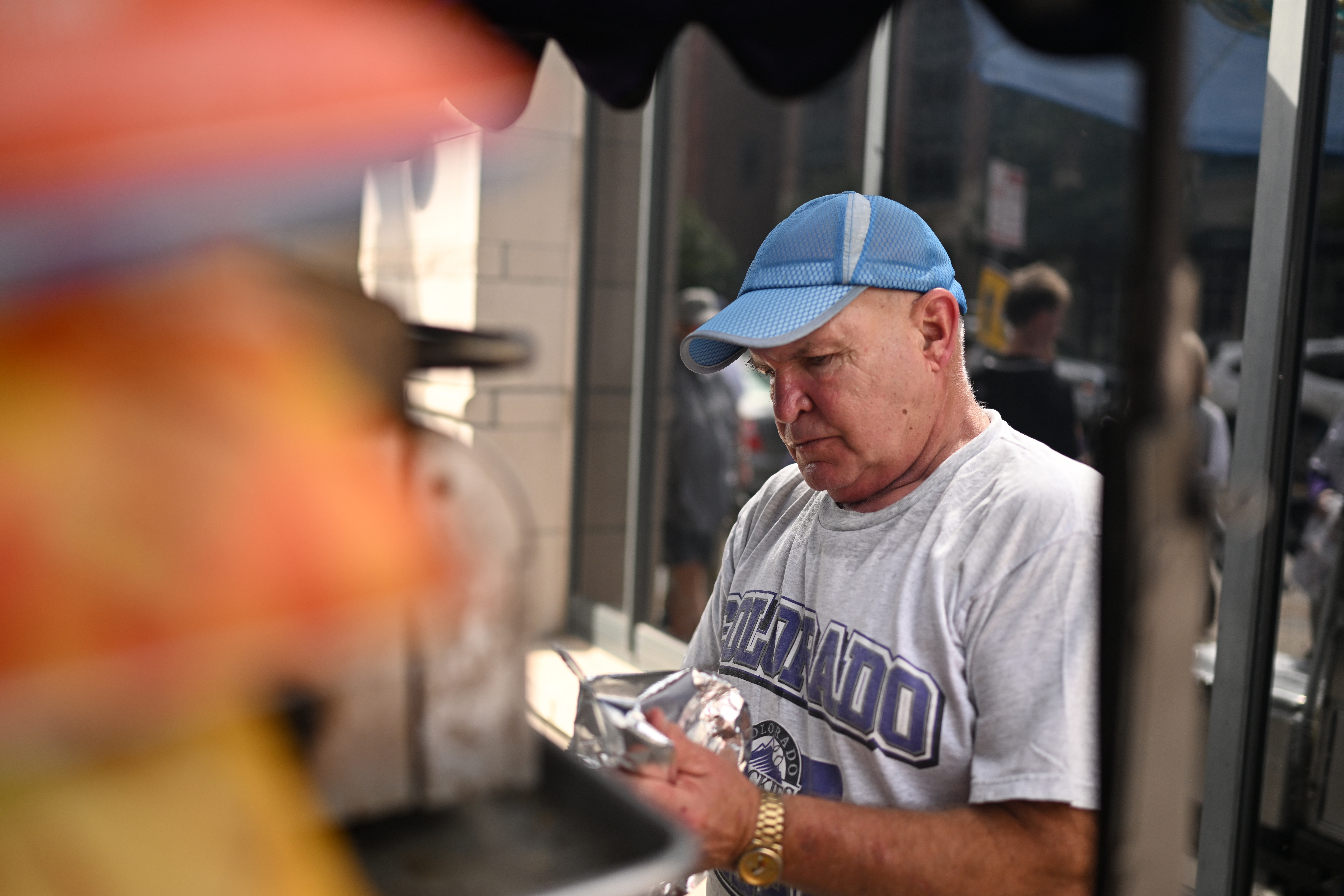 Joel Watkins works his hot dog stand at 19th and Wynkoop streets on Thursday, Sept. 24, 2026, in Denver. (Photo by RJ Sangosti/The Denver Post)