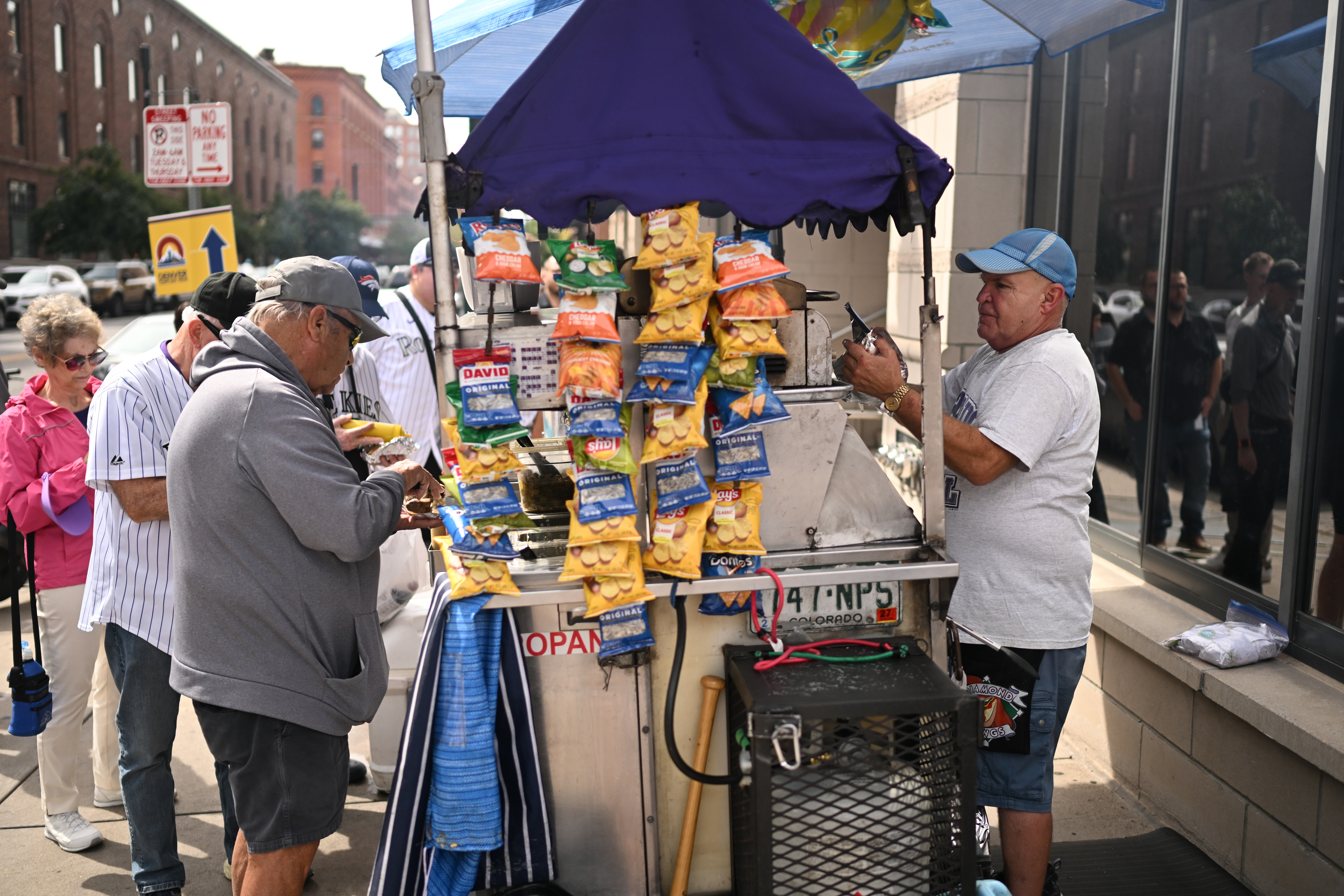 Joel Watkins works his hot dog stand at 19th and Wynkoop streets on Thursday, Sept. 24, 2026, in Denver. (Photo by RJ Sangosti/The Denver Post)