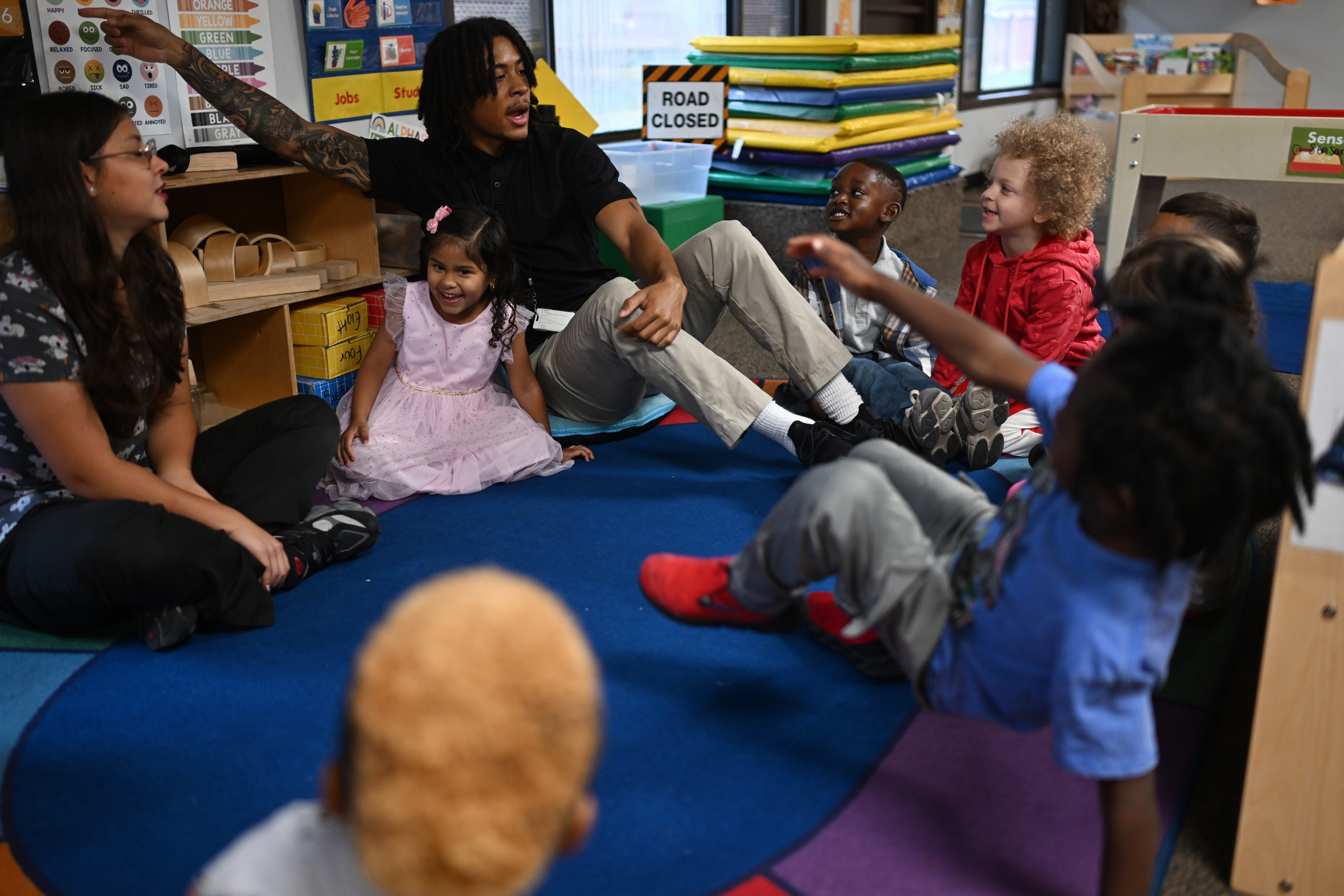 Operations coordinators Alisson Casteblanco, left, and Jaden Cradle talk about feelings with a group of prekindergarten students at Venture for Success Preparatory Learning Center on Thursday, Oct. 1, 2026, in Denver. (Photo by RJ Sangosti/The Denver Post)