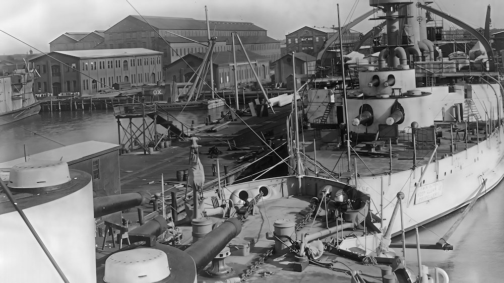 View from the bridge of the Kentucky BB-6 alongside the outfitting pier at Newport News Shipbuilding, in the foreground is the Kearsarge BB-5. Dates to Jan of 1900