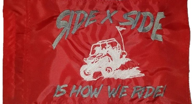 Side X Side Is How We Ride safety flag with embroidered silver and white UTV throwing roost on red nylon rectangle with whip sleeve
