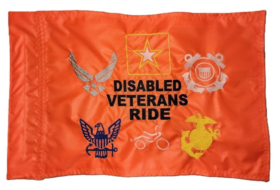 Disabled Veterans Ride safety flag with dense embroidered military branch logos and text on orange nylon rectangle with whip sleeve