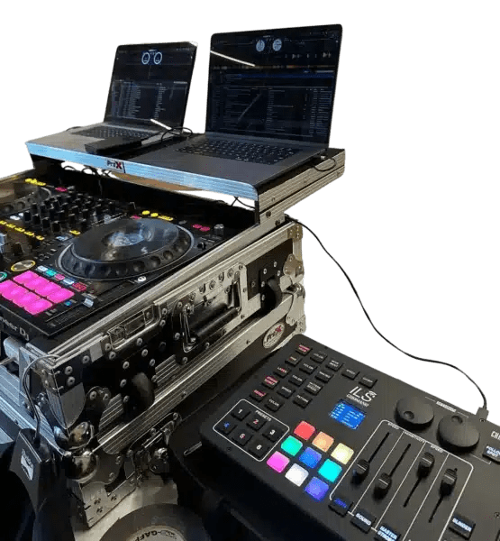 DJ performing live in Grand Rapids, Michigan with turntables and lighting setup, energizing the crowd at a local event