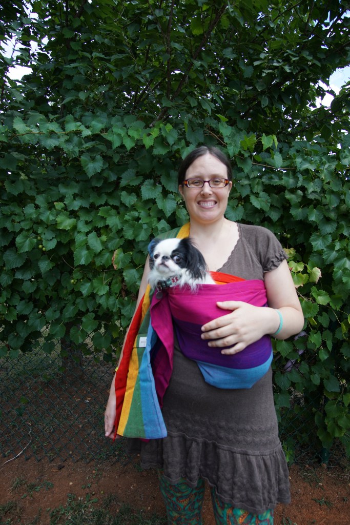 Veronica carrying Hestia in a rainbow sling