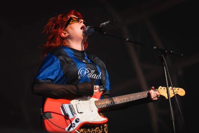 Carla singing with guitar