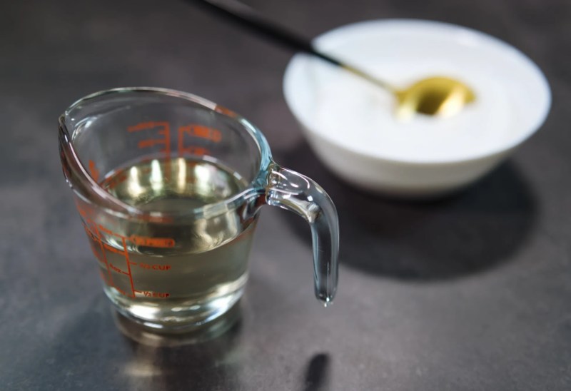 A finished syrup in front of a bowl of sugar