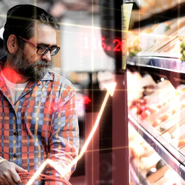 Photo of a man in grocery store looking to represent inflation in Canada