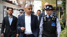 Sadiq Khan walking with a group of police officers on a London street