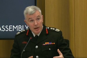 A man in a black uniform talking
