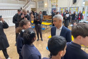 Sadiq Khan talking to a group of school children in a school hall