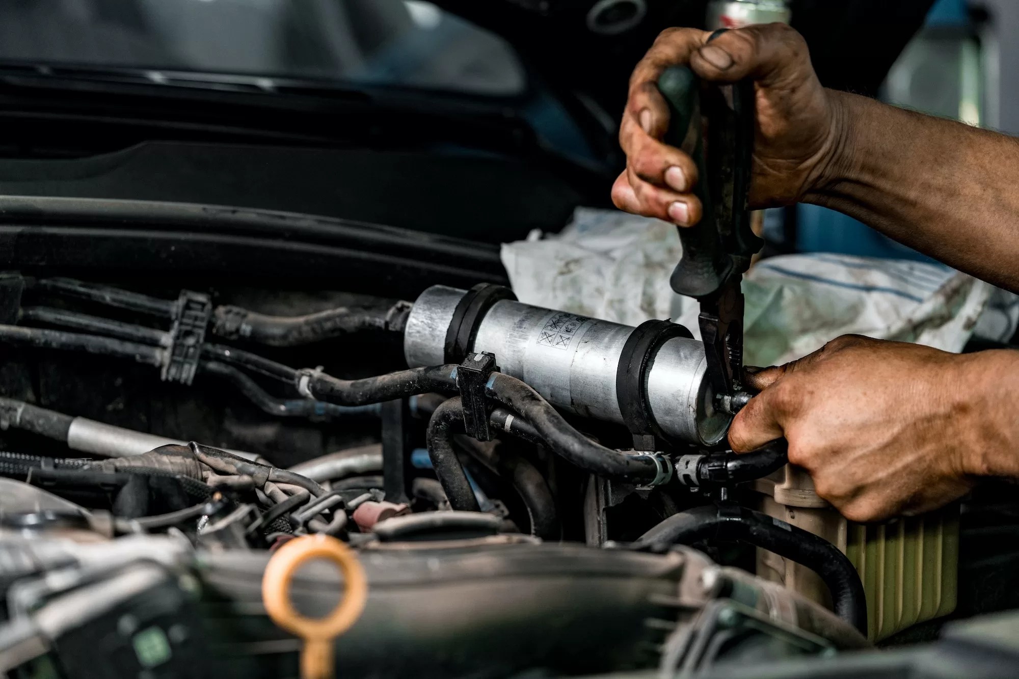 Close up of auto mechanic repairing car engine in car service