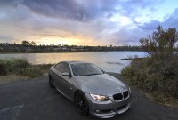 BMW E92 335i Gray BMW E92 335i coupe parked by a lagoon at sunset