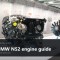BMW N52 inline-six engine on a museum display stand, with a caption band reading BMW N52 engine guide