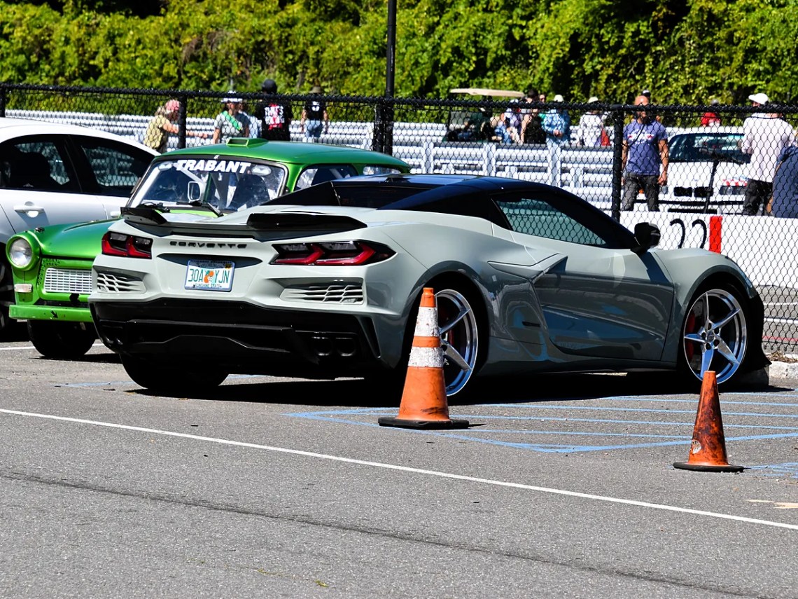 Corvette E-Ray convertible Gray Chevrolet Corvette E-Ray convertible parked beside traffic cones at a car event, rear three-quarter view