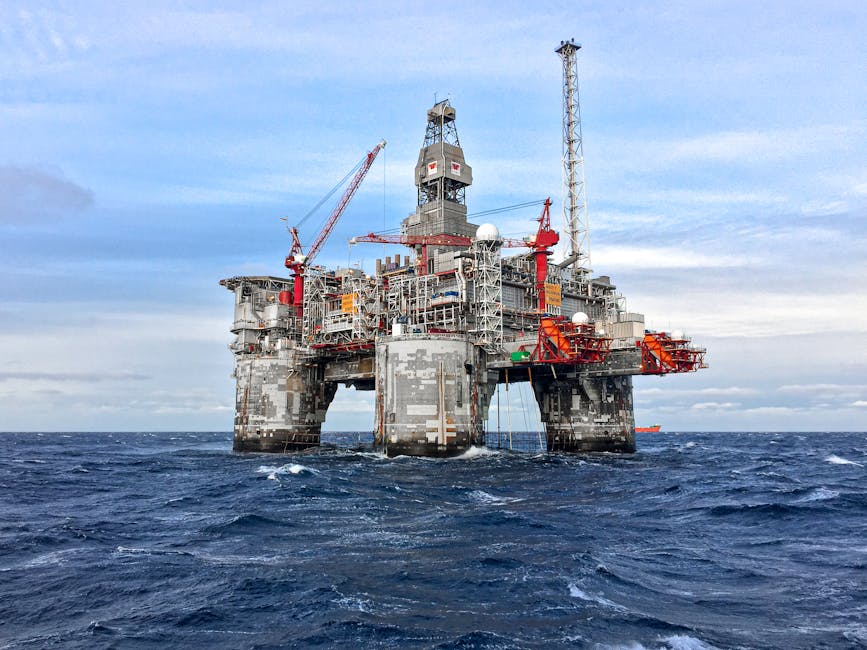 Oil drilling platform in North Sea waters under cloudy sky