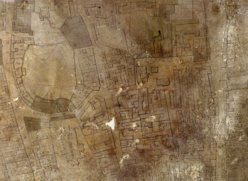 SW Map after After conservation work. The map is still very dark due to the layer of discoloured varnish which cannot be removed, but it has been flattened and tears and holes filled in. Despite the damage it has suffered, the outlines of the streets and buildings are remarkably clear.