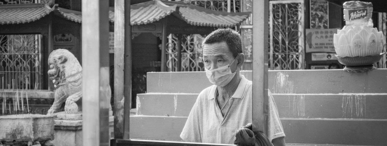 grayscale photo of man wearing a facemask