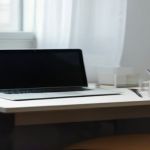 Dual workspace layout showcasing programming code and text analysis documents on a modern desk setup.