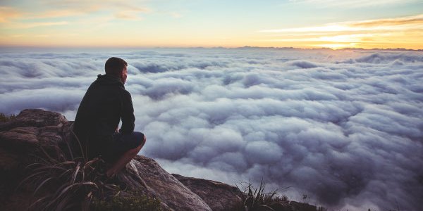 Person Contemplating Clouds