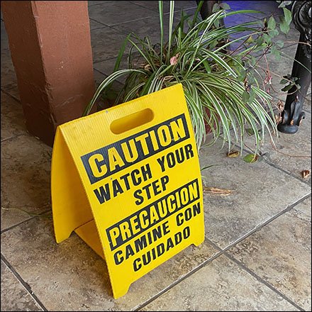 Multilingual Watch Your Step Warning Waits For Rain