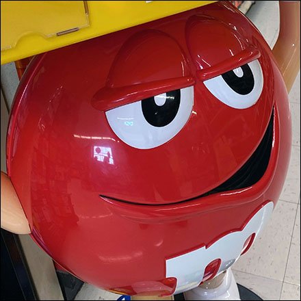 M&M's Red Weightlifter Display Hefts Its Load Overhead