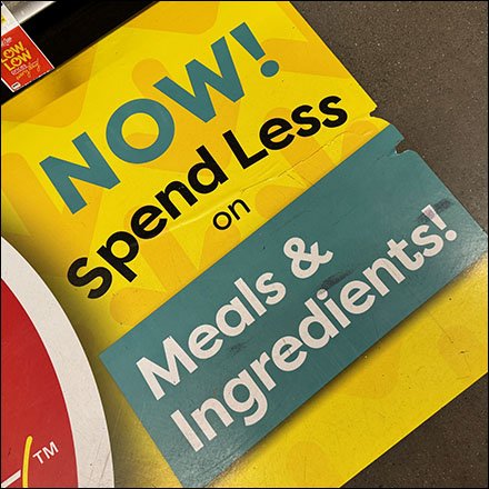 Now Spend Less Floor Graphic Promises More