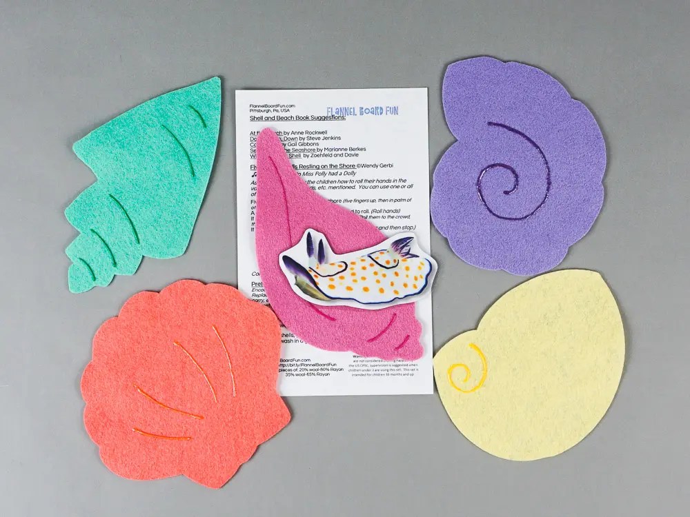 Five shells felt board set around a lyric card with a laminated cardstock nudibranch.