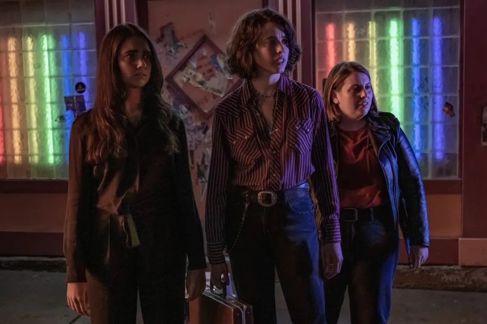 Marianne, Jamie, and Sukie stand outside a lesbian bar.