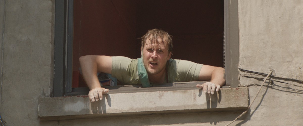 Terry leans over an open window.