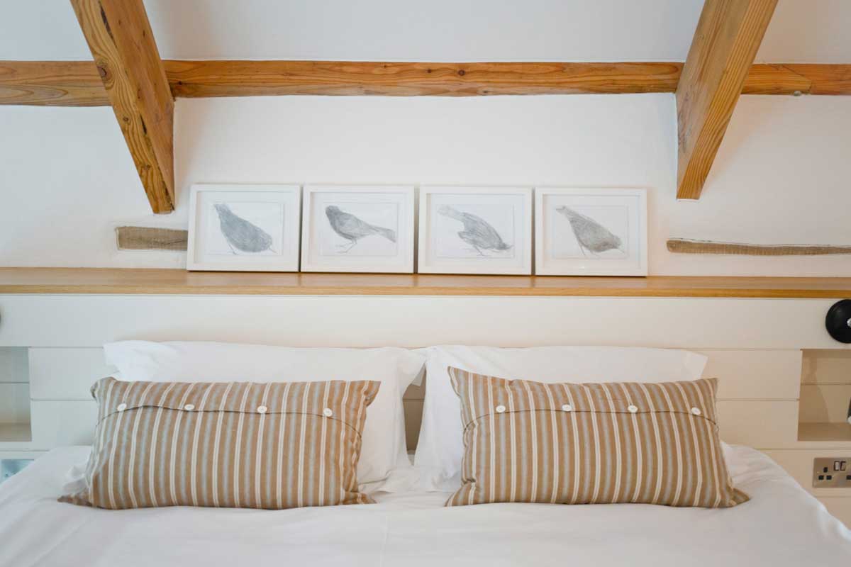 Pillows on bed inside Howthere Barn boutique holiday cottage at Kestle Barton near Helford