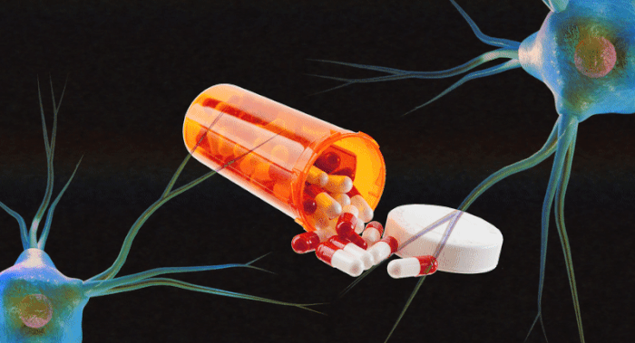 A bottle of ADHD medicine with pills falling out of it.