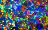 "Woodstock". Rice bran oil bubbles floating on water. The background is a reflective silvery material which I have crumpled up, and the lights pointing down onto it are reflecting rainbow colours back up through the water and drops of oil towards the camera. This year is the anniversary of Woodstock, and I thought that Woodstock would be a suitable name for the sixties retro look of this psychedelic photo. I think it would look good printed onto a large stretched canvas.