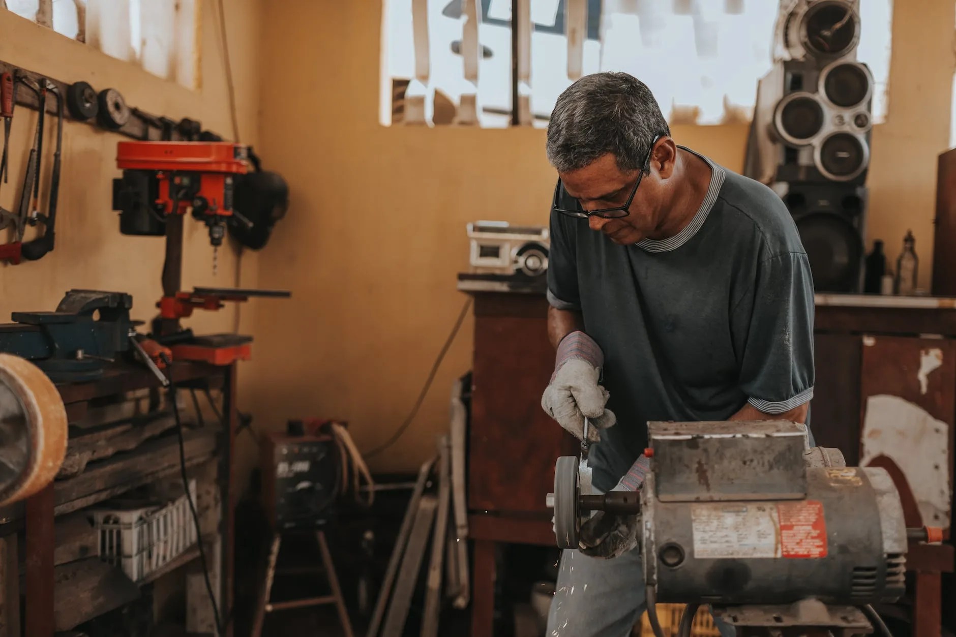 man using bench grinder