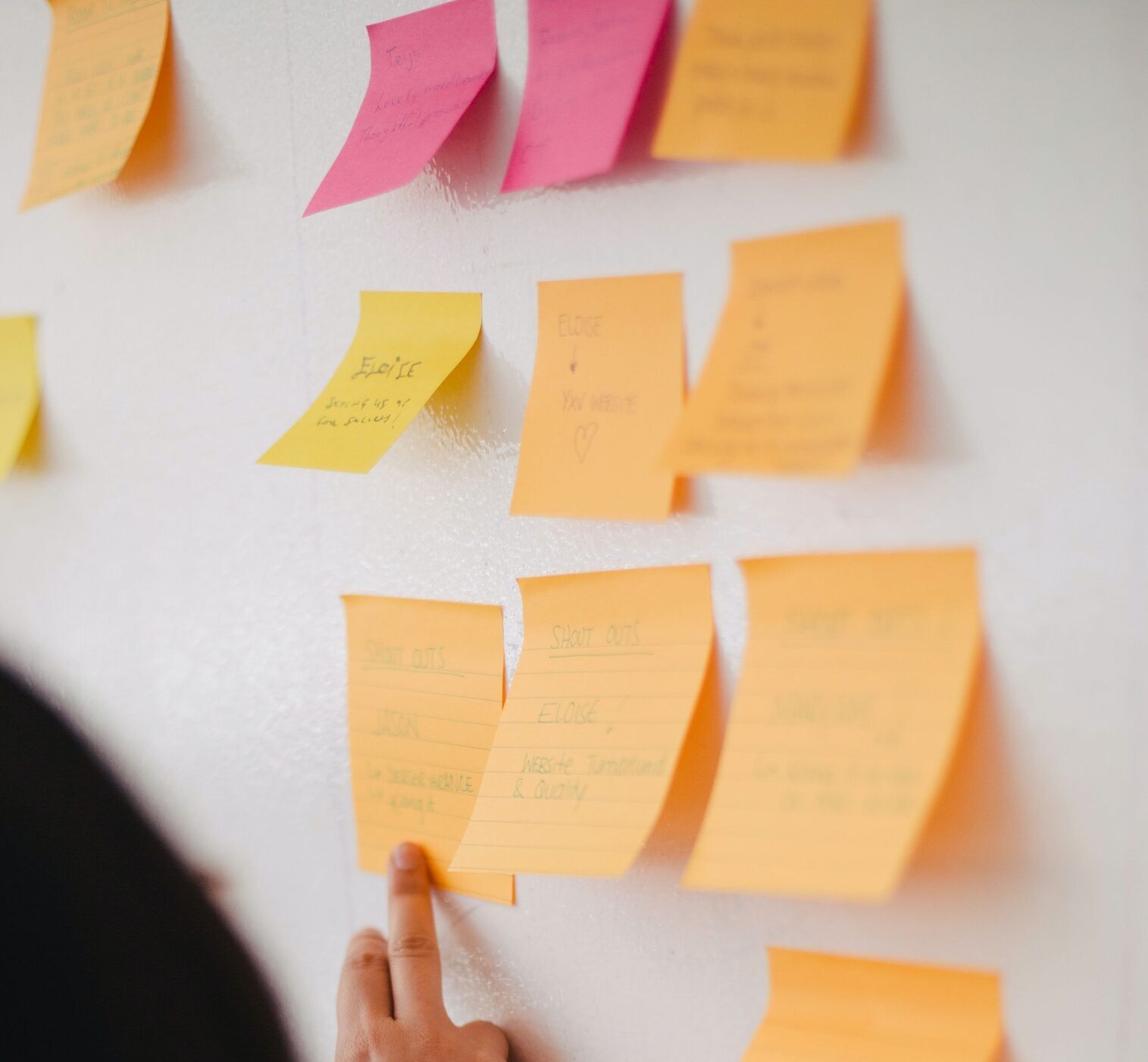 Ideas on sticky notes during a design thinking workshop