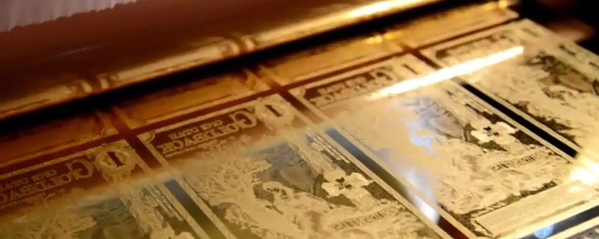 Goldback notes shown in background with soft focus