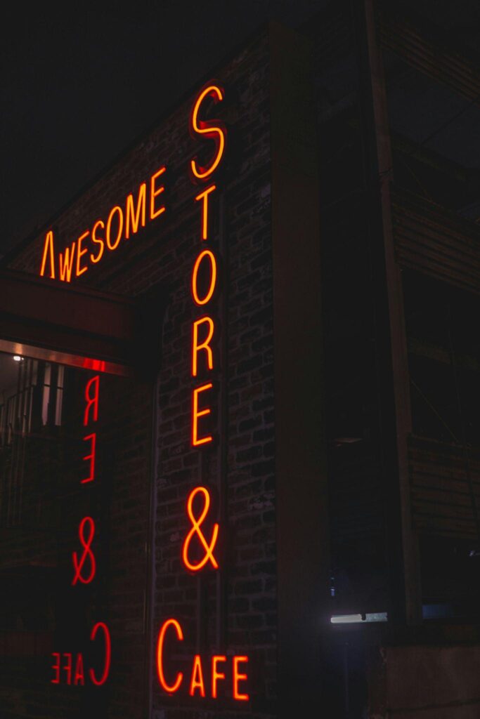 Neon Store and Cafe sign outside a retail business that could benefit from ATM placement services.