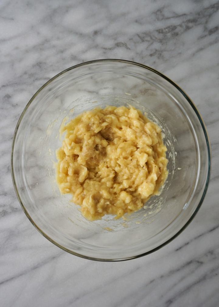 Mashed Bananas in a clear glass mixing bowl