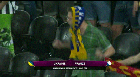 A Ukranian fan dances at Euro 2012 during a rain delay.