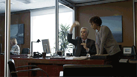 Dikembe Mutombo swats paper at an office for commercial.