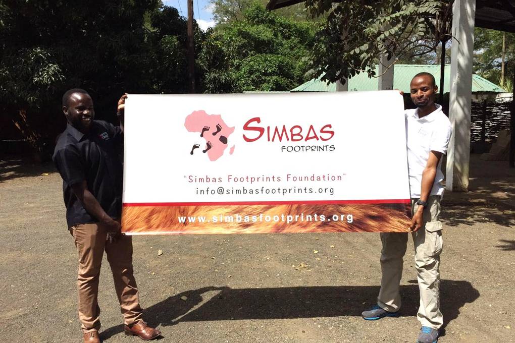 two man holding large banner
