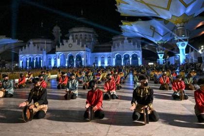 Penari membawakan tarian tradisional Rapa'i Geleng saat pembukaan Festival Ekonomi Syariah (FESyar) Sumatera 2022 di depan Masjid Raya Baiturrahman, Banda Aceh, Kamis malam, 4 Agustus 2022. Foto: Chaideer Mahyuddin/AFP