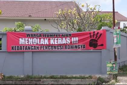 Spanduk dipasang warga yang menolak pengungsi Rohingya dipindahkan ke Markas PMI Aceh di Gampong Ajuen Jeumpet Kecamatan Darul Imarah Aceh Besar