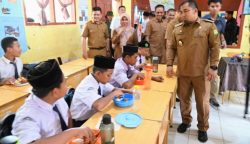 Pj Bupati Aceh Besar Muhammad Iswanto saat menghadiri peluncuran simulasi program makan siang gratis bagi pelajar SMP Negeri 1 Darul Imarah, Aceh Besar, Selasa (5/3)