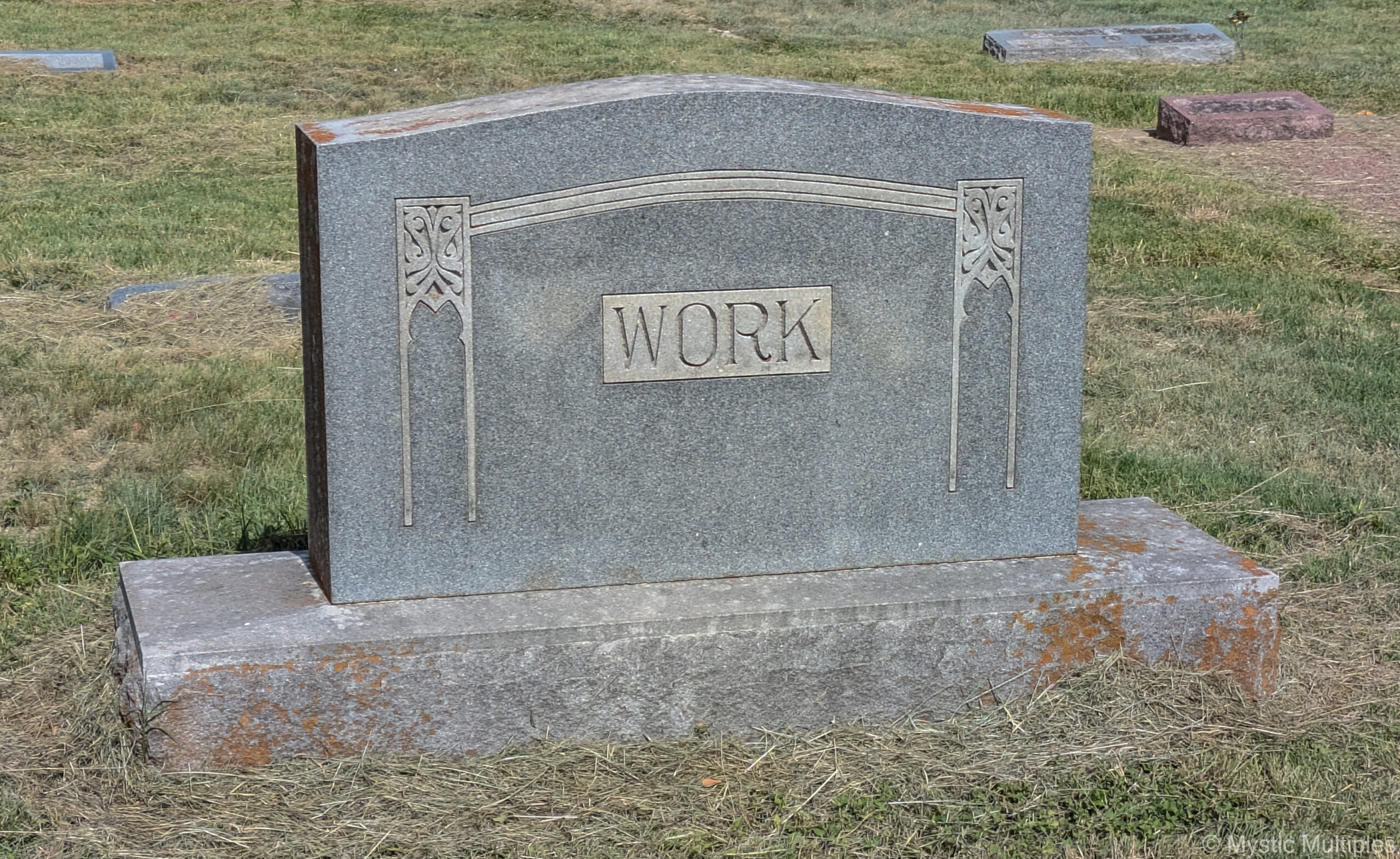 A tombstone that reads WORK
